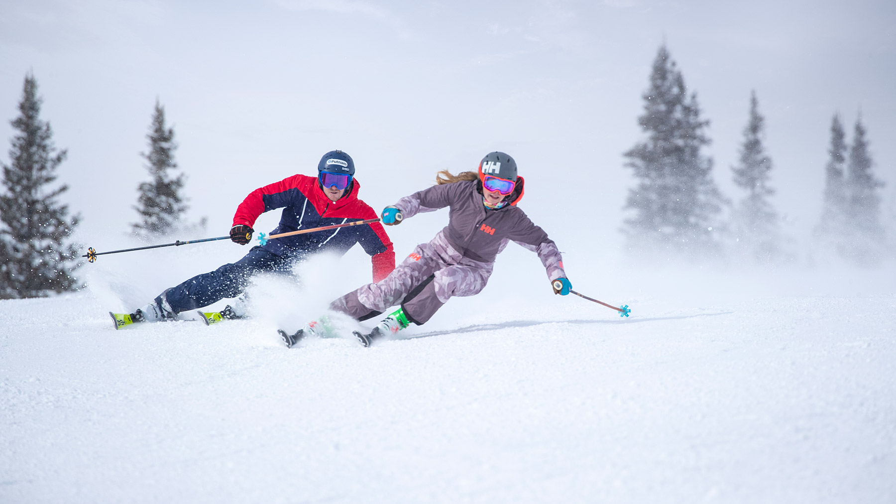 Two guests skiing a groomed run at Deer Valley Resort