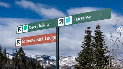 Deer Valley trail sign for Deer Hollow ski run, Fairview ski run, and Snow Park Lodge.