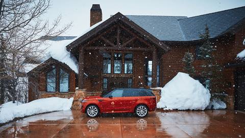 Red Range Rover in front of lodging property.