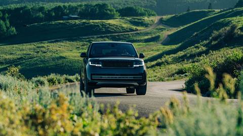 Range Rover in the mountains on a scenic drive in the summer