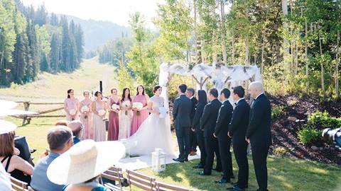 Bride and groom with bridal party during ceremony at Deer Valley's Empire Canyon Lawn