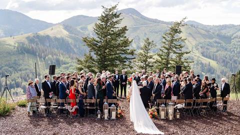 Bride walking down aisle at wedding ceremony at Deer Valley's Cushing's Cabin