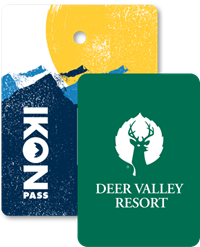 Collage of season passes, Ikon Pass creative in the back, and a Deer Valley Resort pass in front.