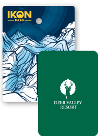 Collage of season passes, Ikon Pass creative in the back, and a Deer Valley Resort pass in front