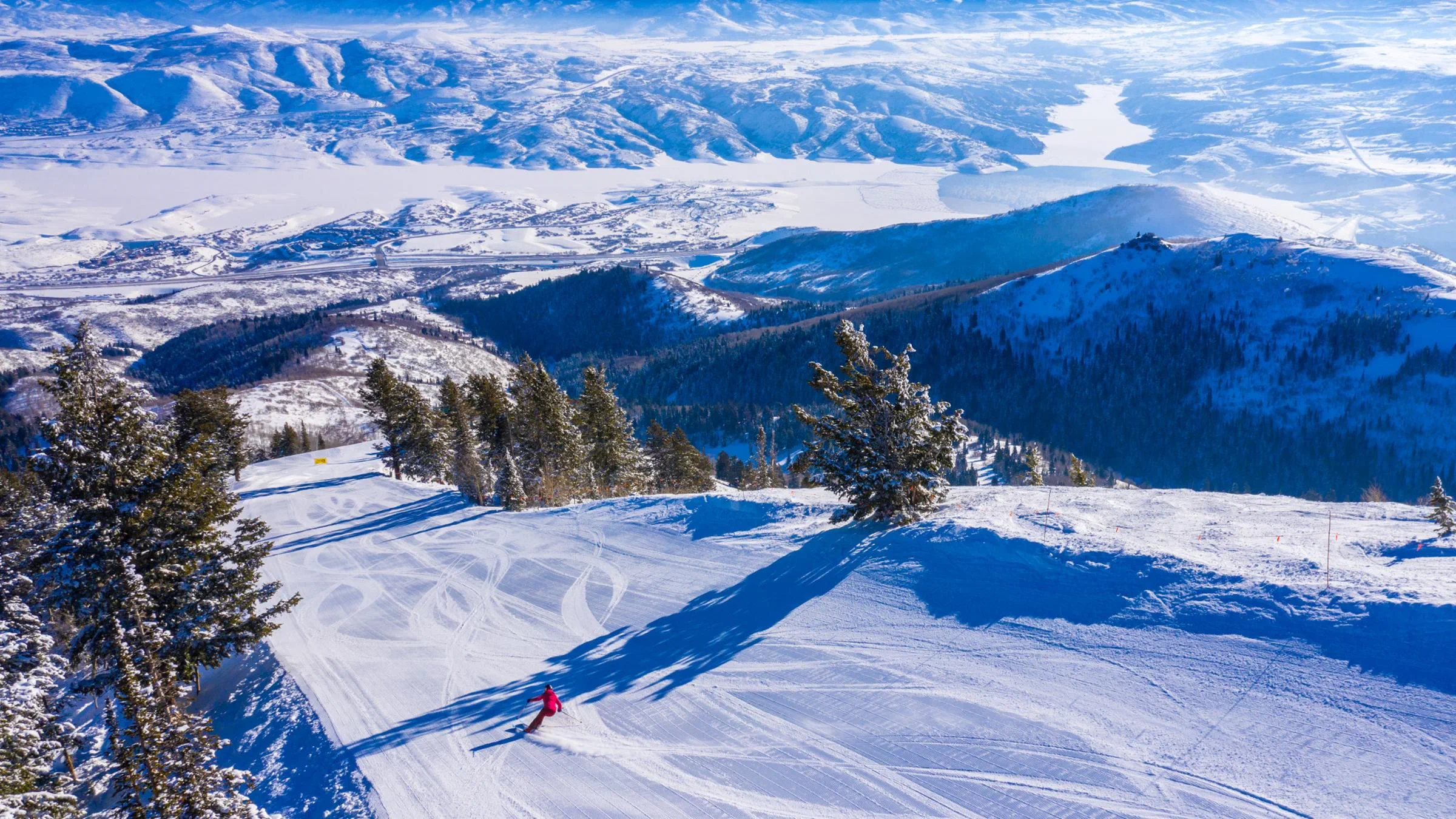 A guest skiing on a groomed run at Deer Valley Resort