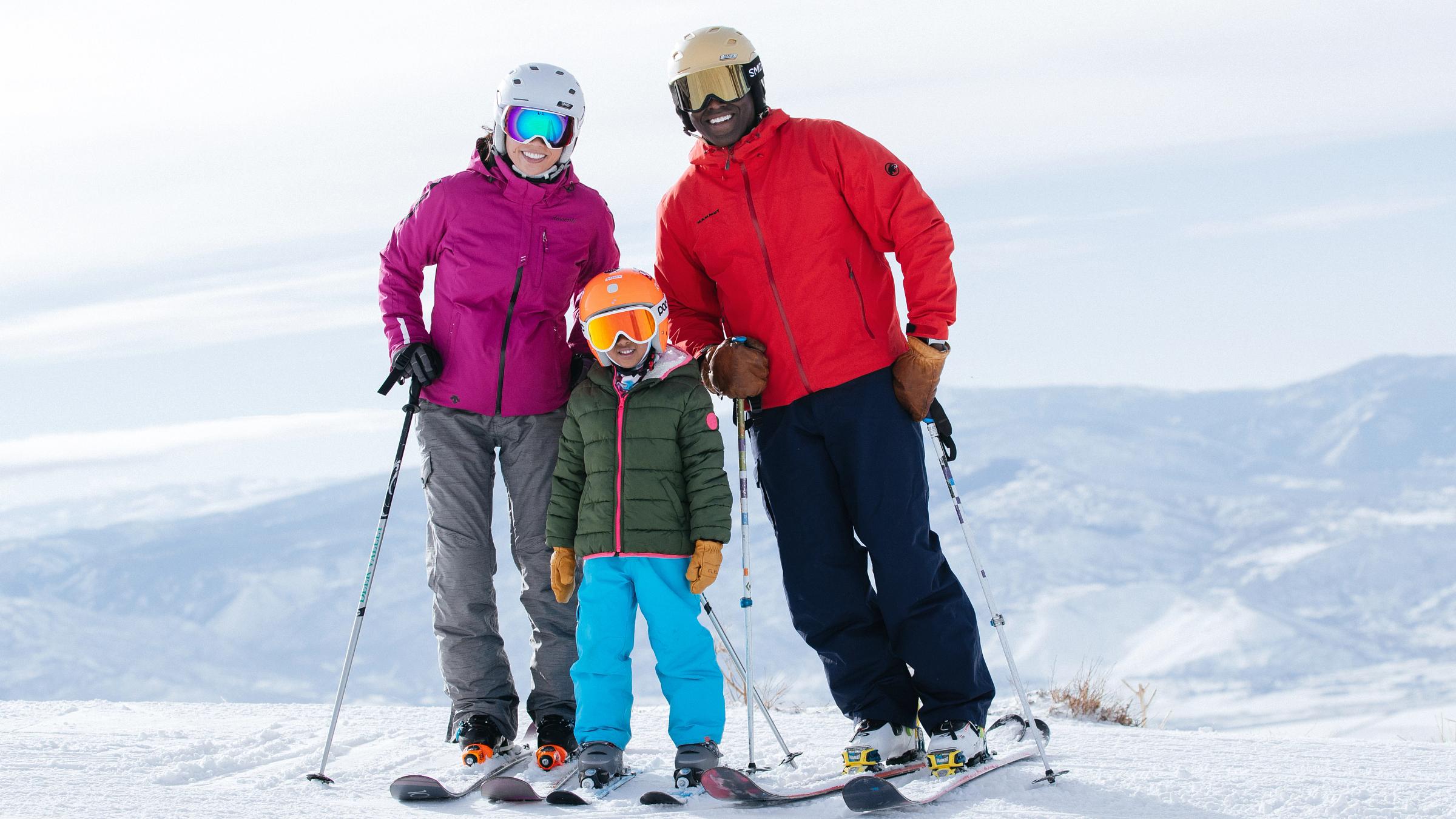 Family poses on top of a slope at Deer Valley