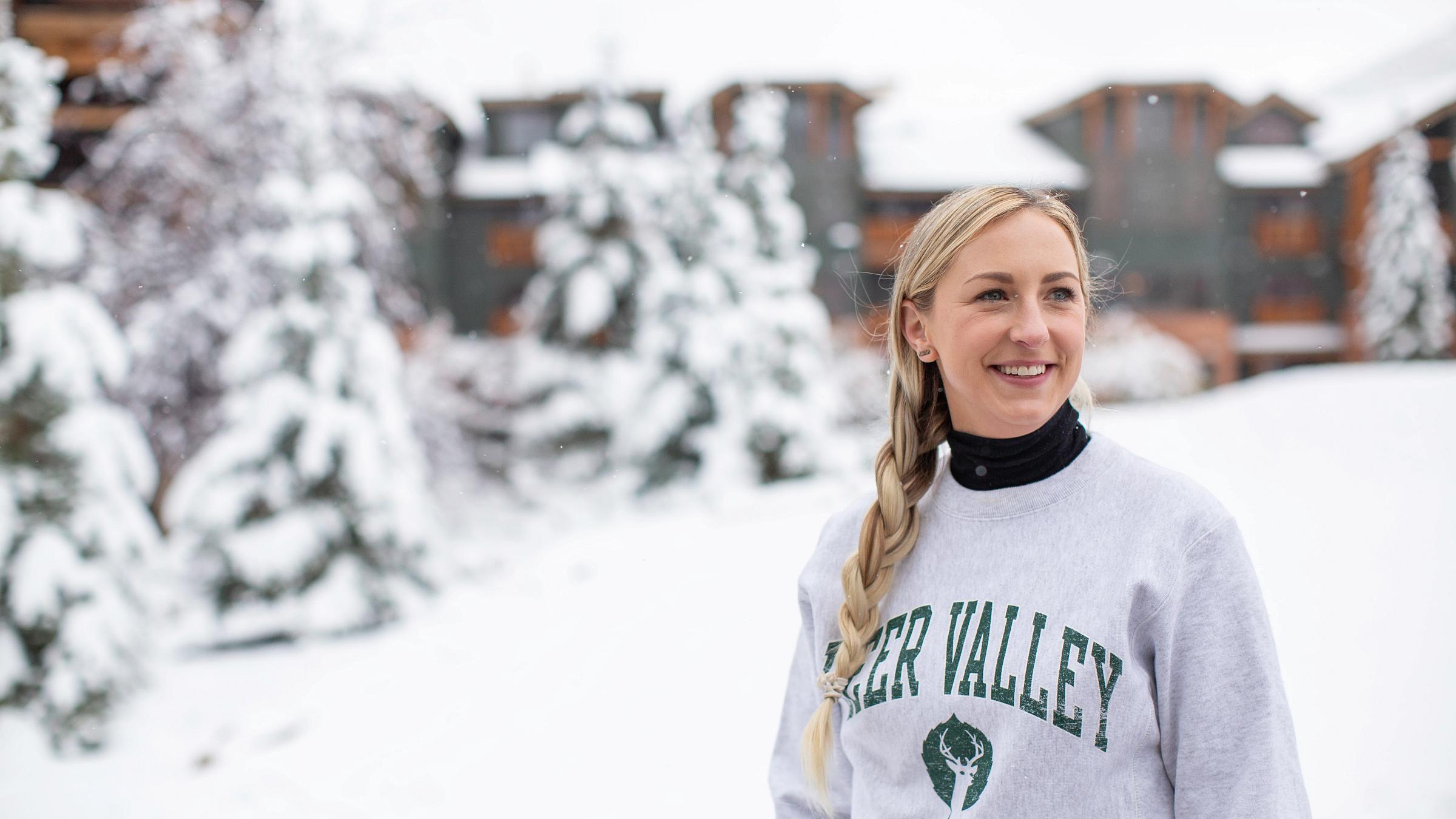 A guest smiling with a Deer Valley sweatshirt on