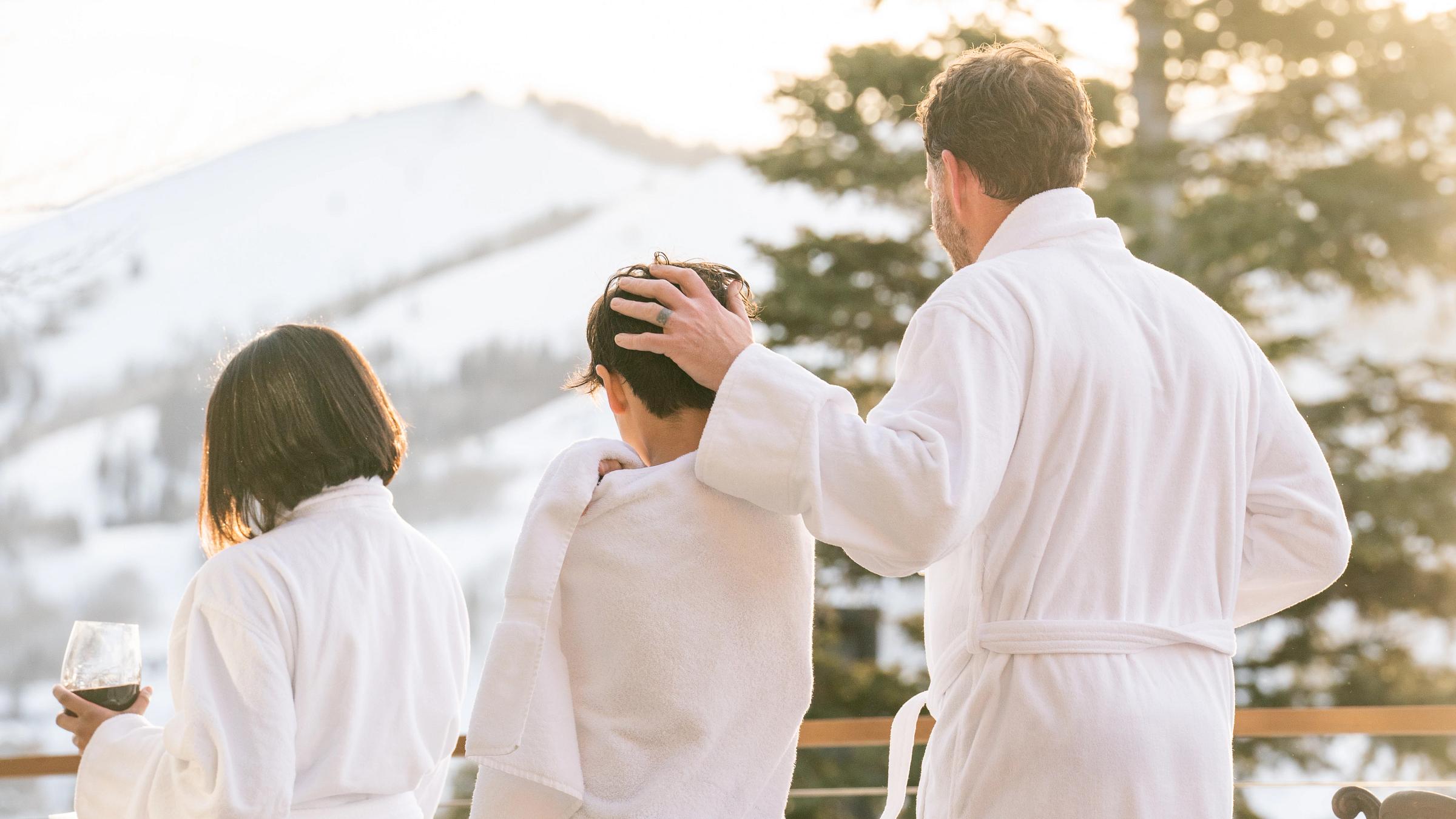 Father and child in robes after the pool