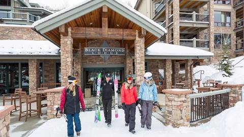 Guests walking out onto the ski run at Black Diamond Lodge