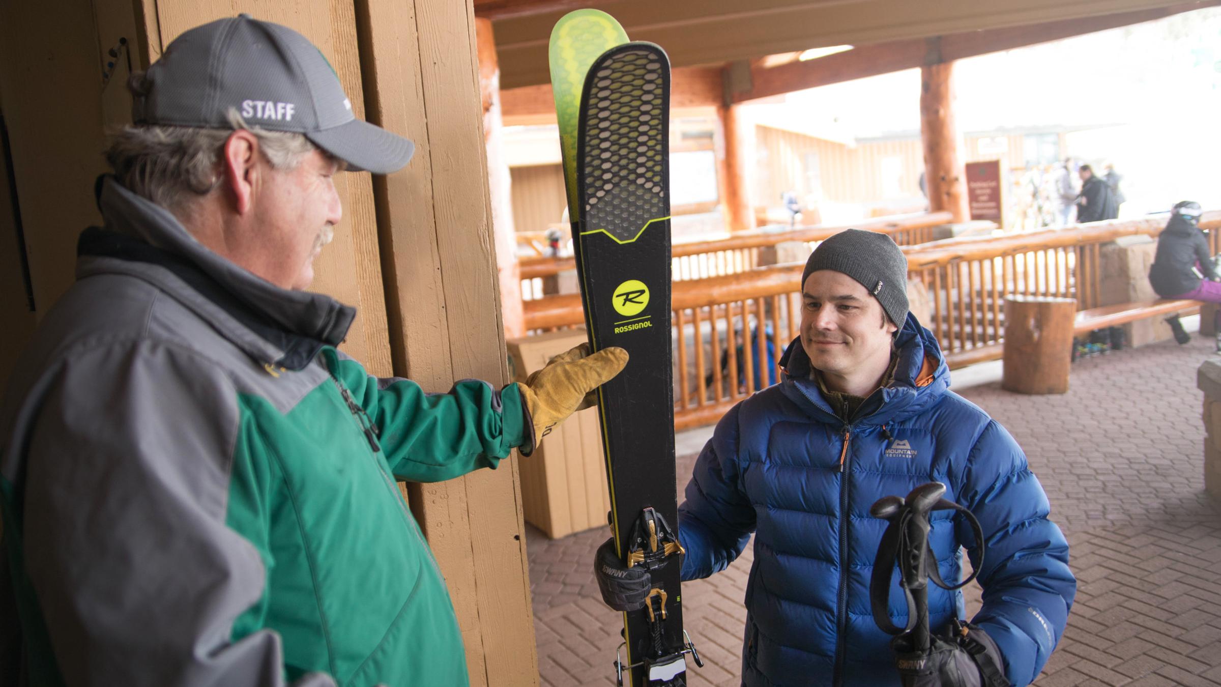 A guest receiving their skis at the ski corral
