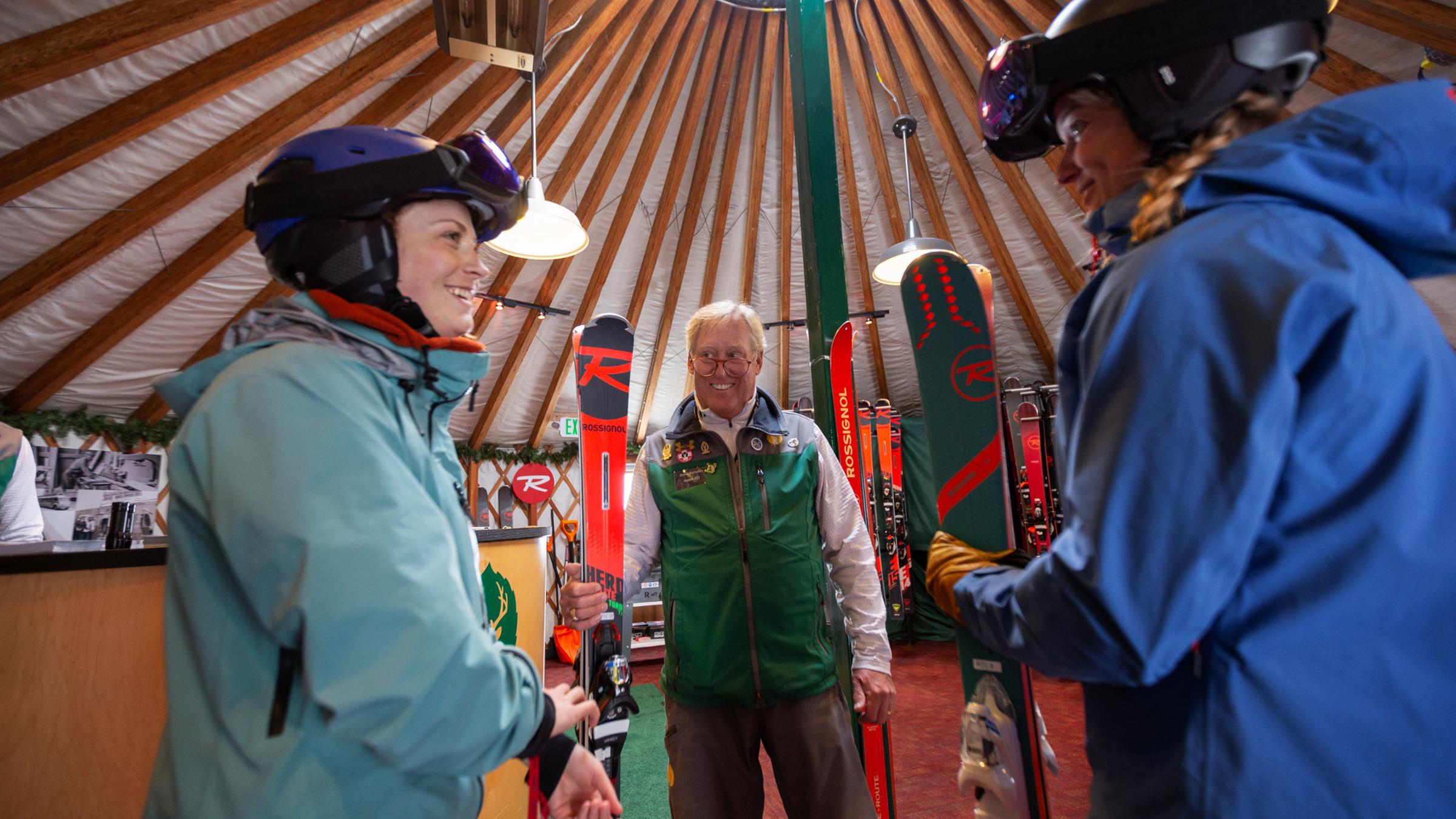 Two guests receiving skis at the Rossignol High Performance Test Yurt