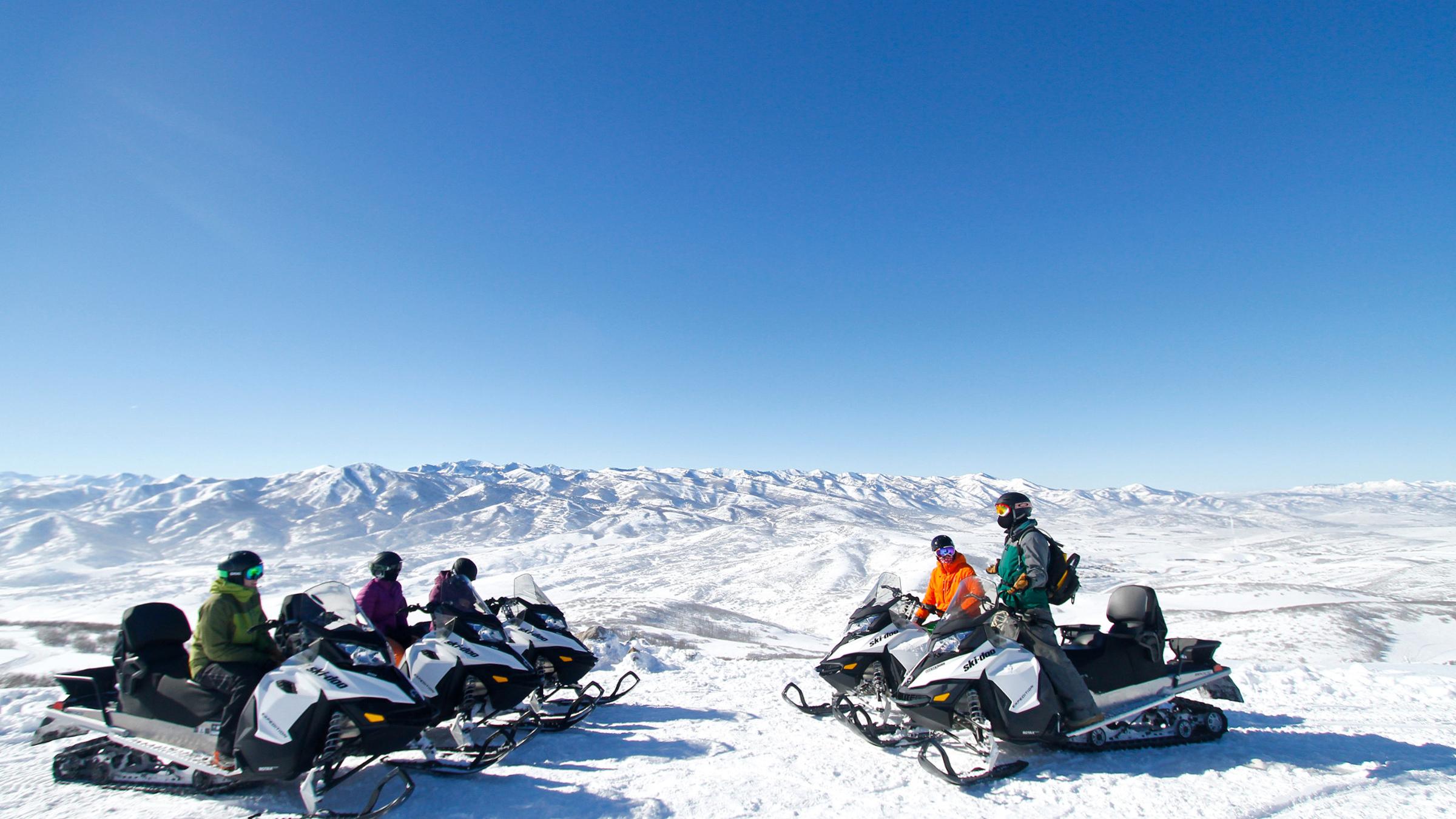 A group of guests snowmobiling