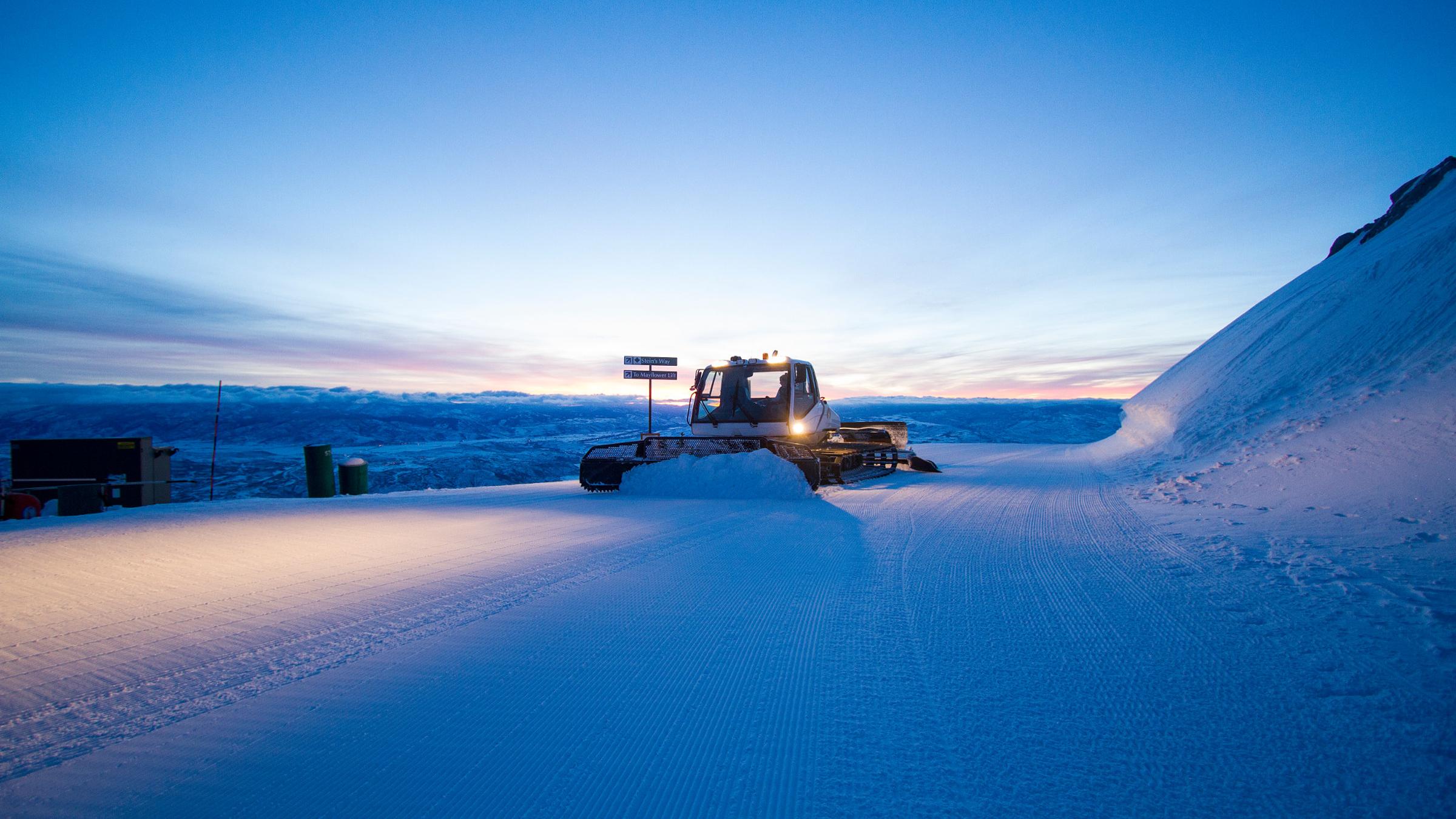 Groomer operates a snowcat to prepare slopes at Deer Valley