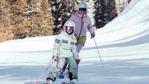 Mother and daughter skiing in Helly Hansen