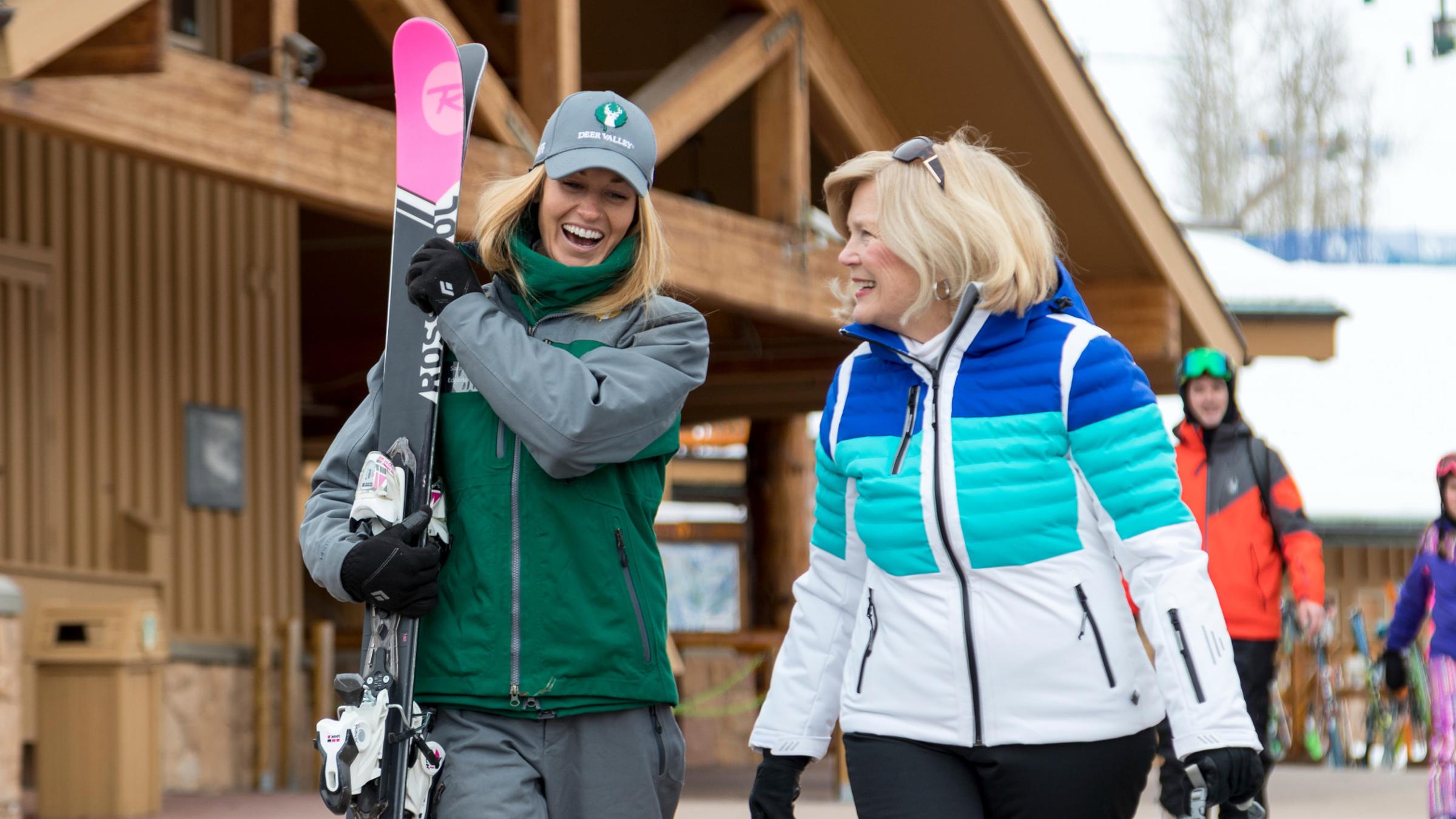 Guest service attendant carrying a guests skis to their car