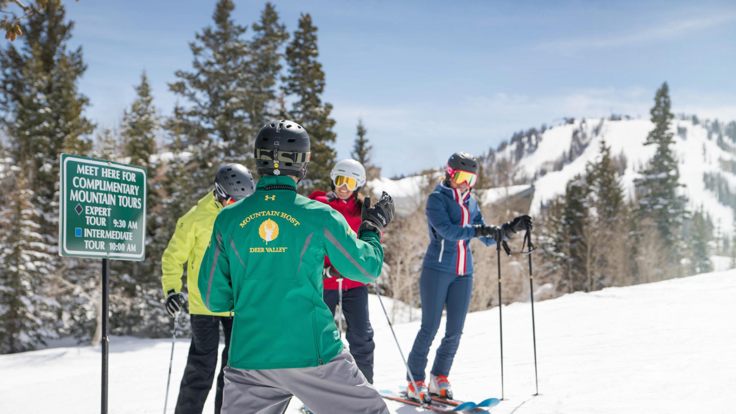 A mountain host with a group at the meeting point