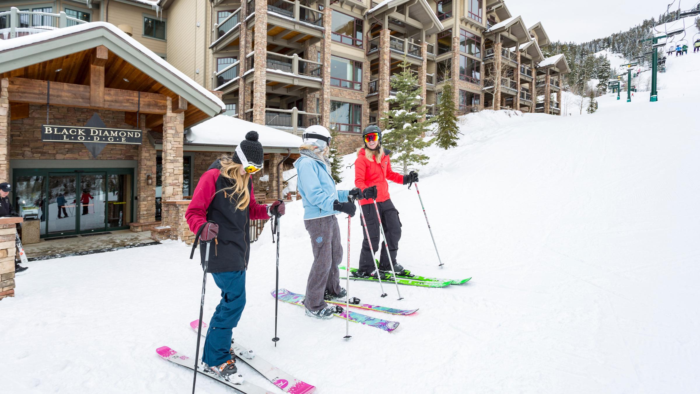 Guests putting their skis on outside of Black Diamond Lodge