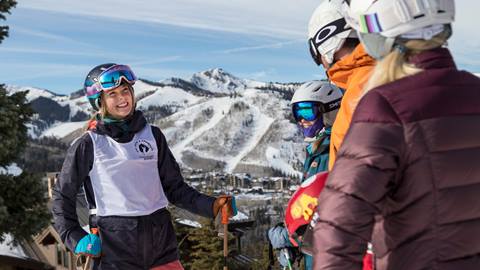 Ski with a champion athlete smiling at guests