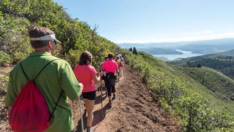 A group of guests on a guided hike with Jordanelle Reservoir in the background
