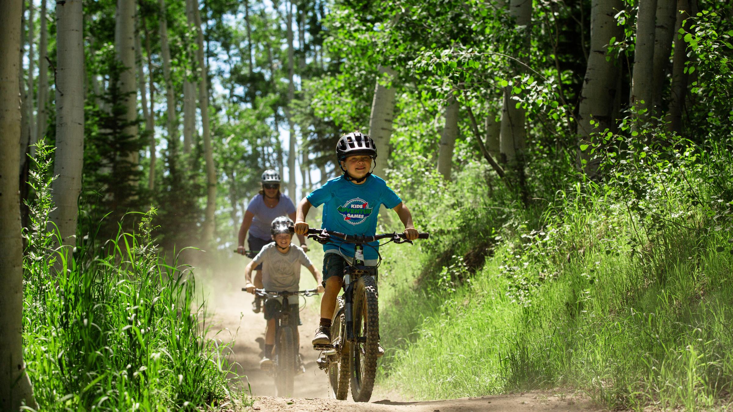 A family mountain biking at Deer Valley Resort