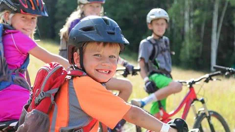 A little boy smiling on his mountain bike