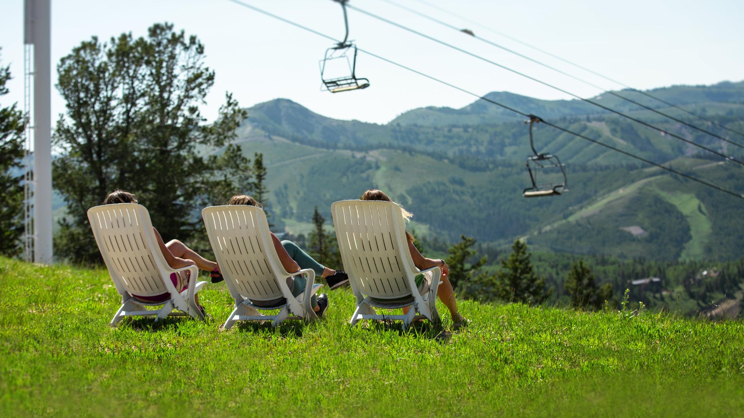 Guests sitting in chair at the top of Bald Mountain