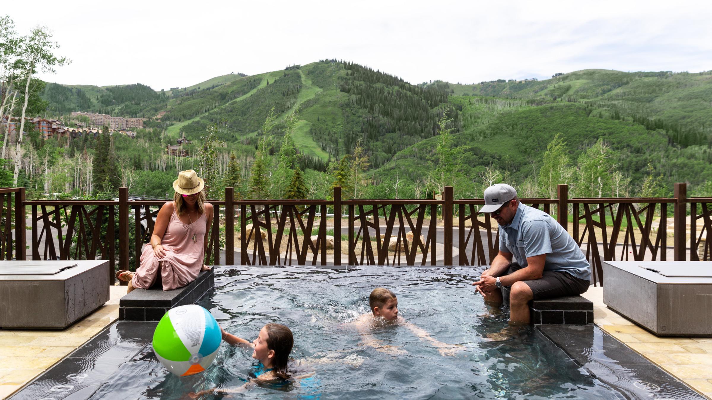 A family in the pool at One Empire Pass