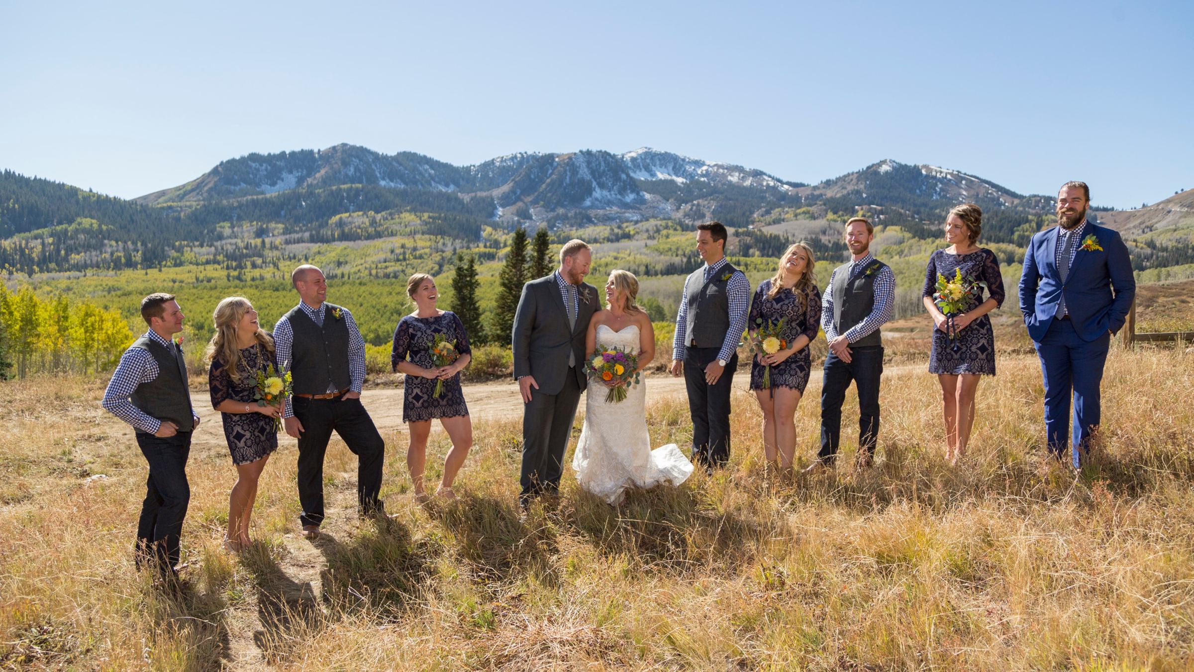 A wedding party outside smiling