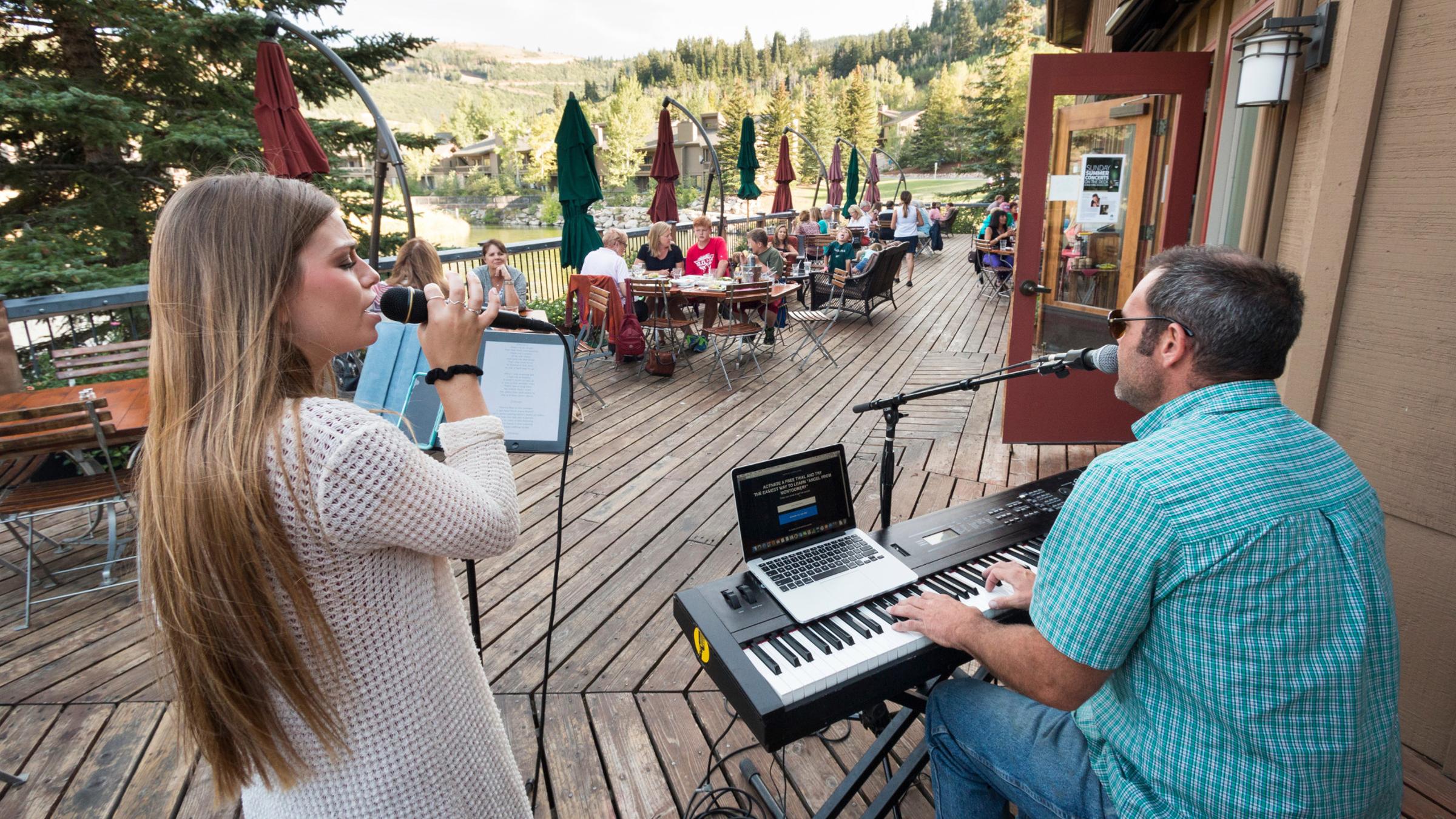 Diners enjoy a concert on the deck at Deer Valley Grocery~Cafe in Park City, Utah