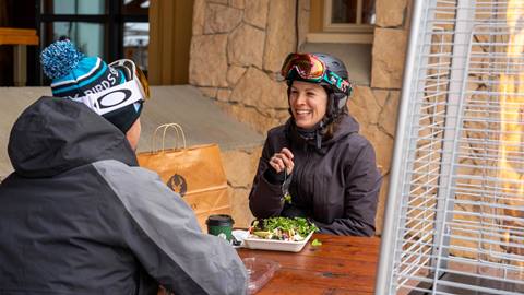 Guests eating food from Snow Park Grab and Go