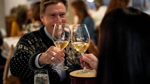 Couple cheers wine at Goldener Hirsch Inn