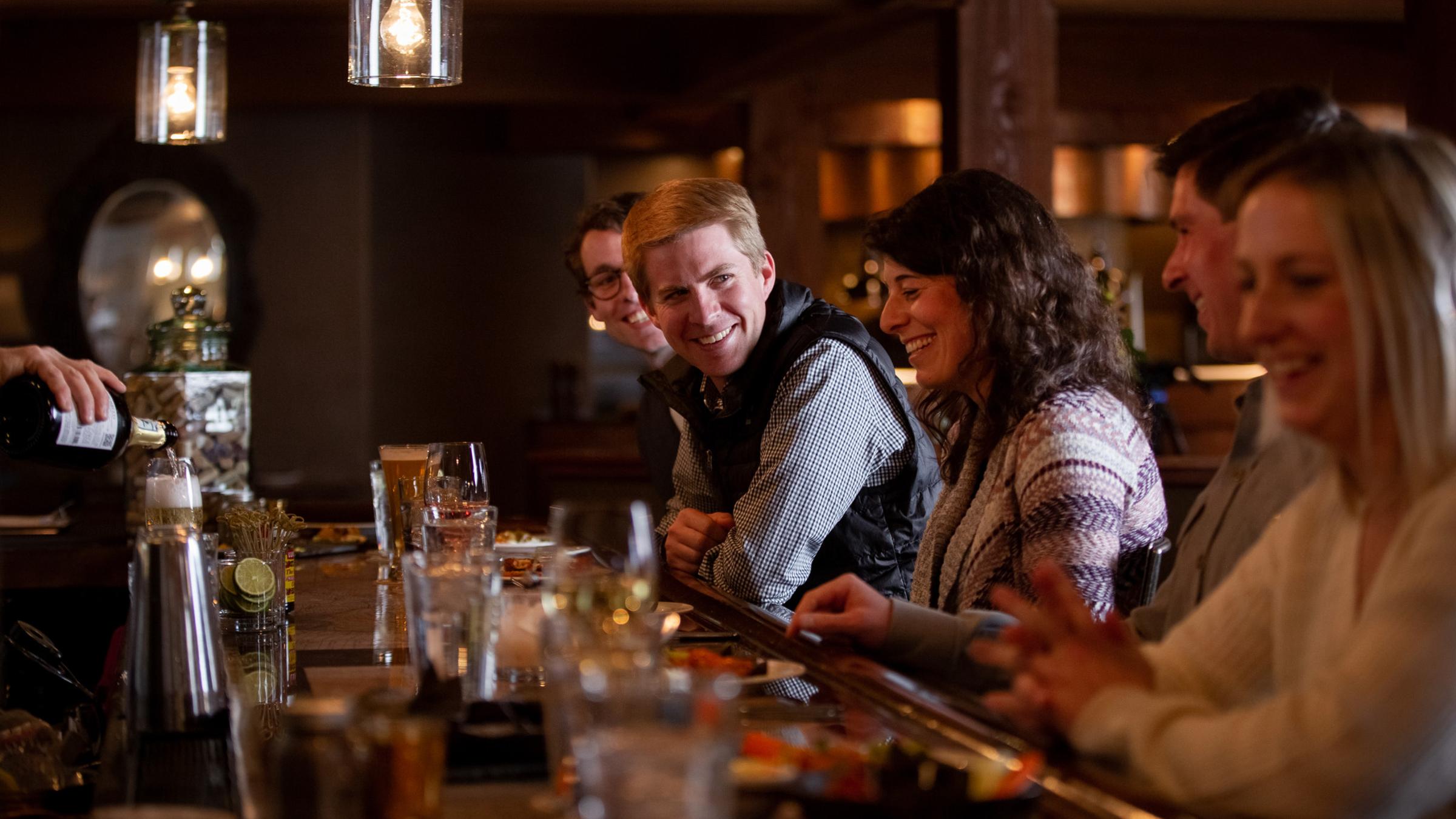 A group of guests at The Brass Tag bar having drinks and appetizers