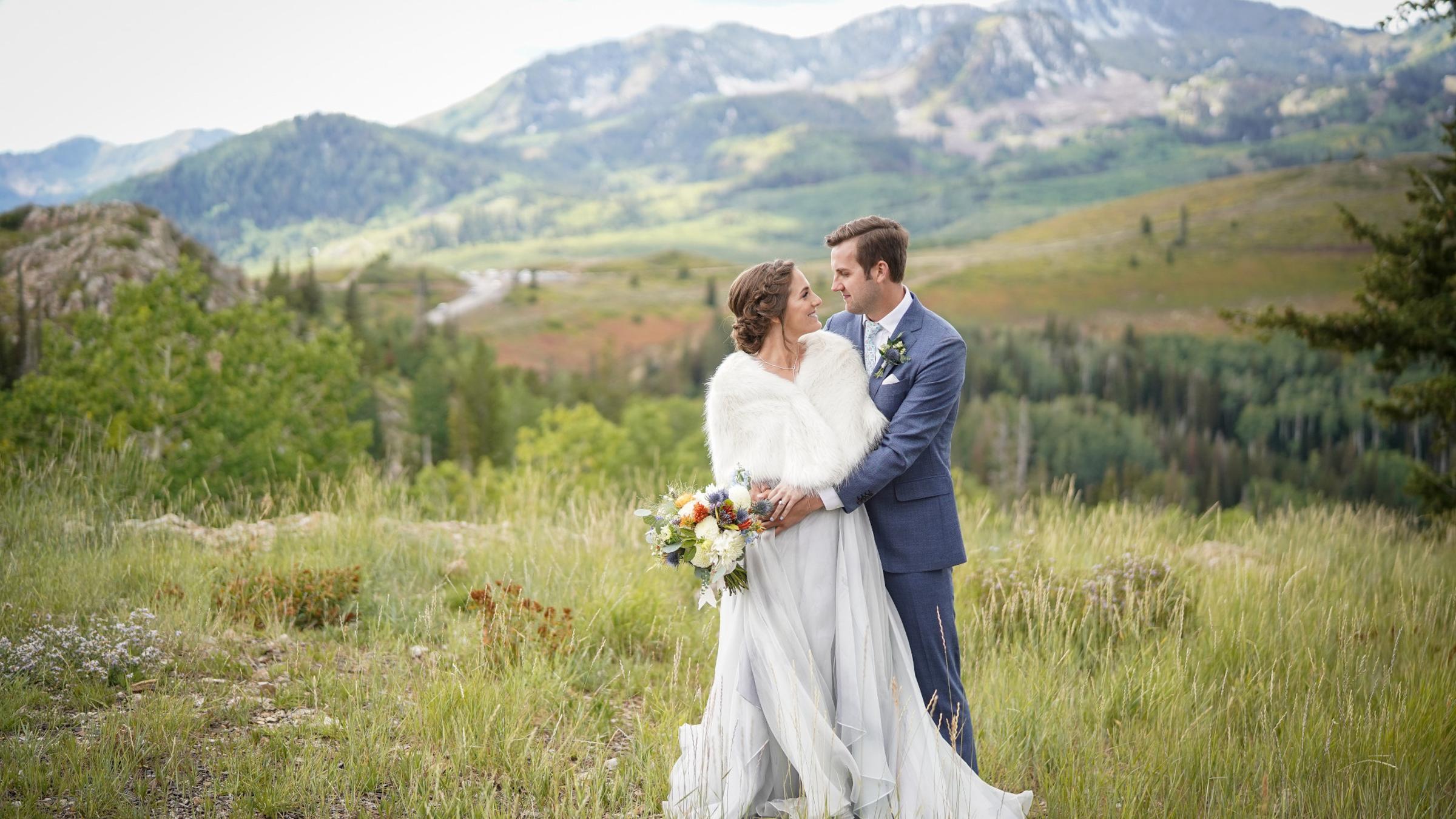 A bride and groom smiling at each other