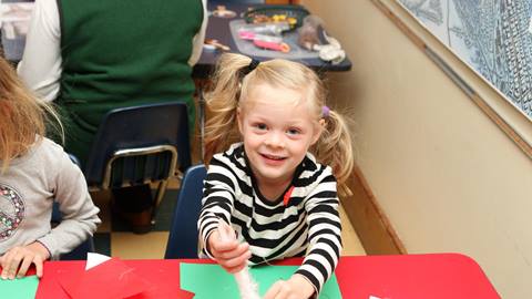 a little girl doing arts and crafts