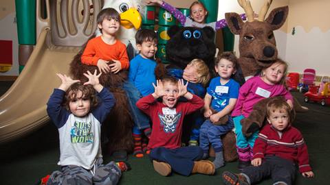 A group of children smiling and laughing with Deer Valley Mascots