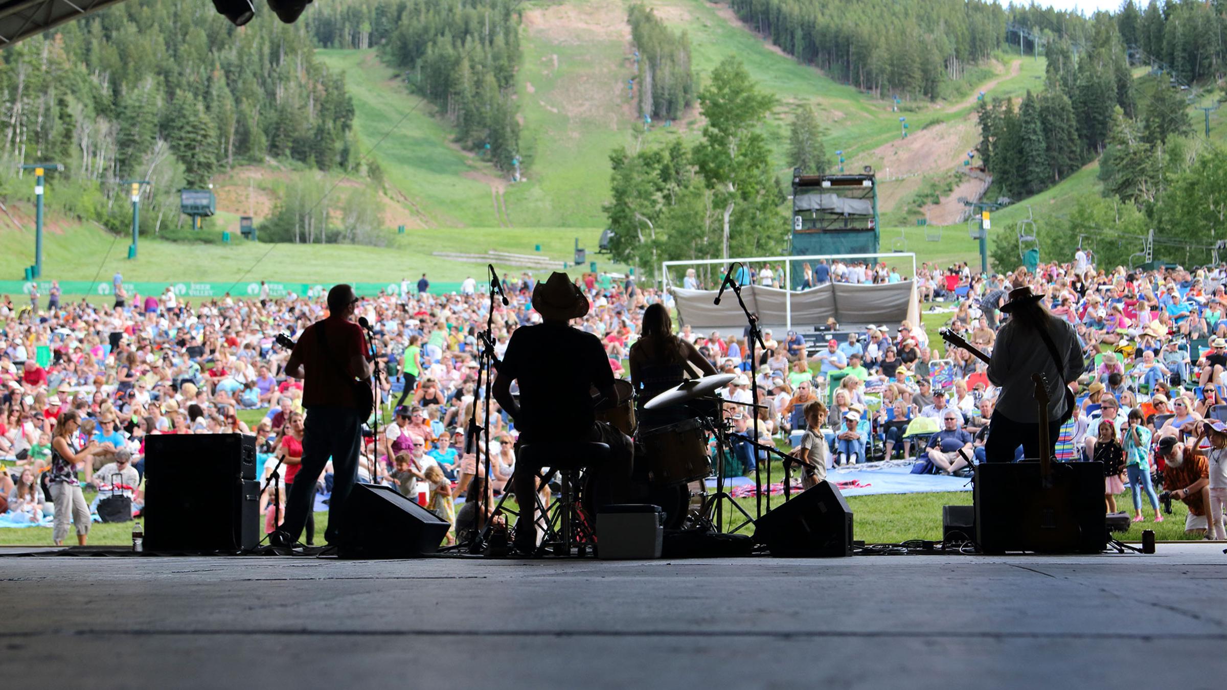 a band performing on the snow park outdoor amphitheater stage