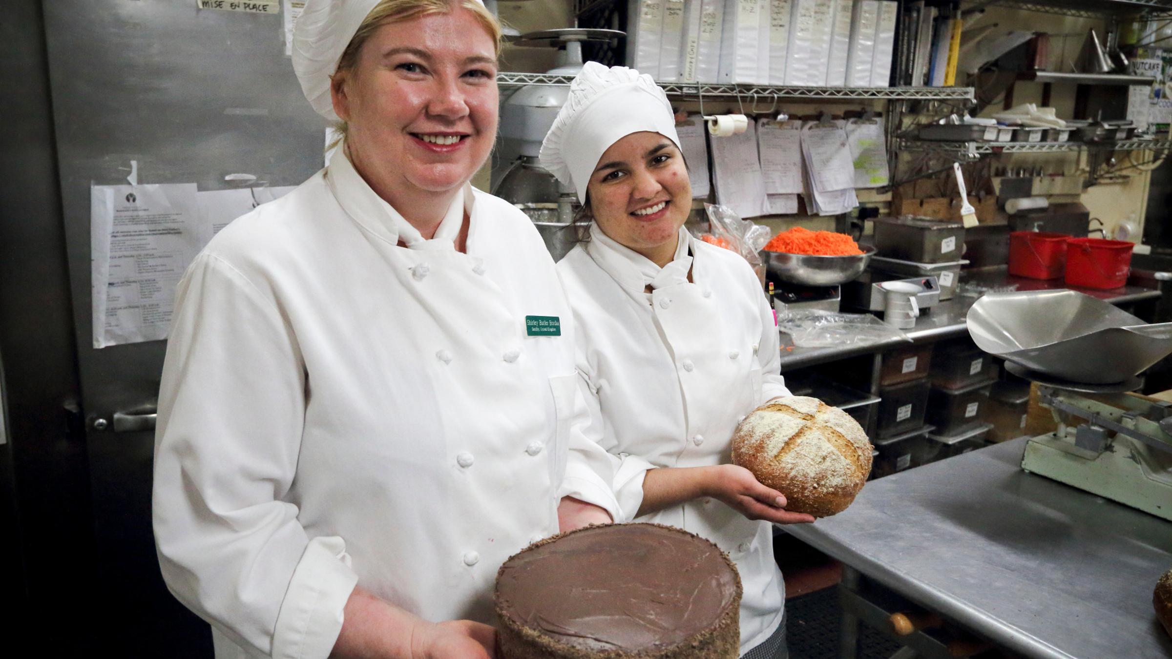 Baker taking out bread from an oven