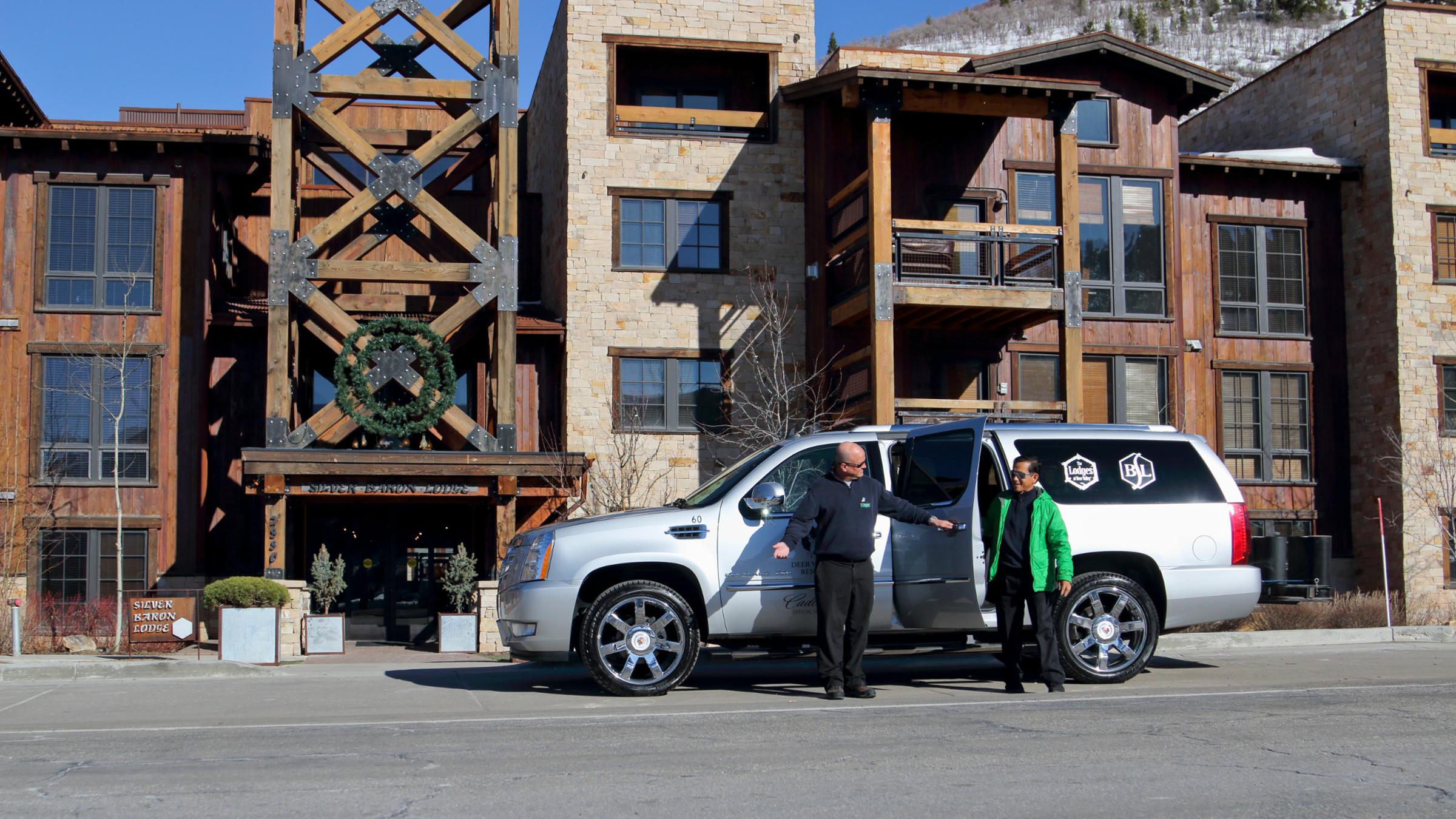 A guest getting out of a Deer Valley Cadillac