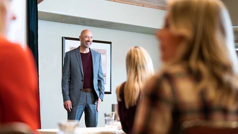 Presenter delivering speech in a Deer Valley conference room