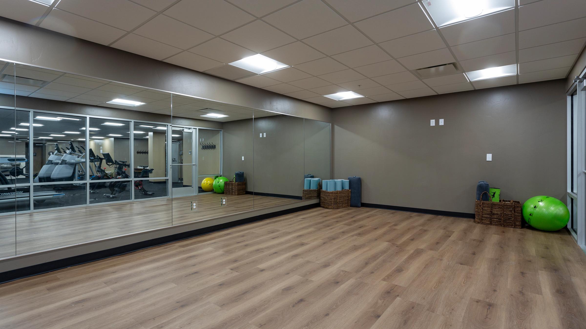 Mirrored walls and hardwood floors in the Silver Baron yoga studio.