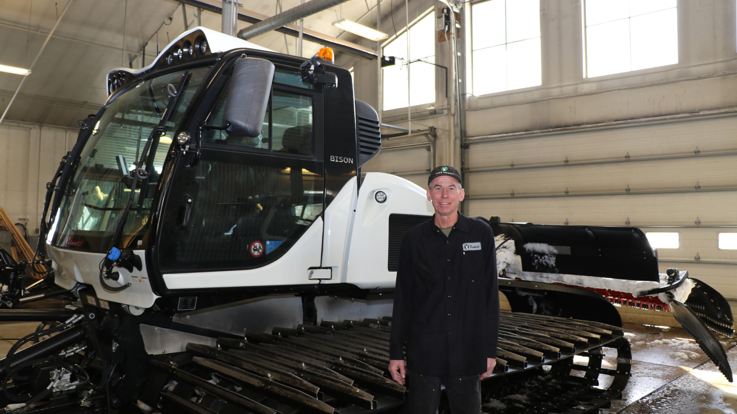 Deer Valley mechanic in front of a snow cat